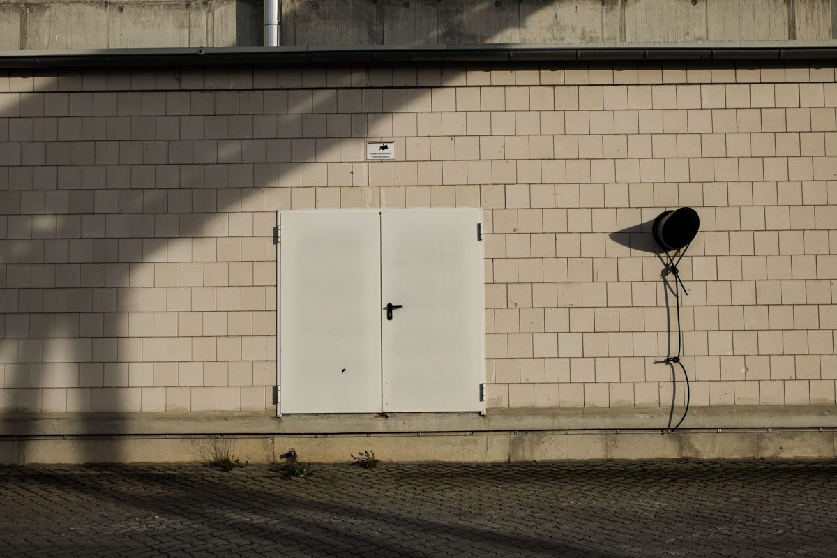 a white door on a brick wall