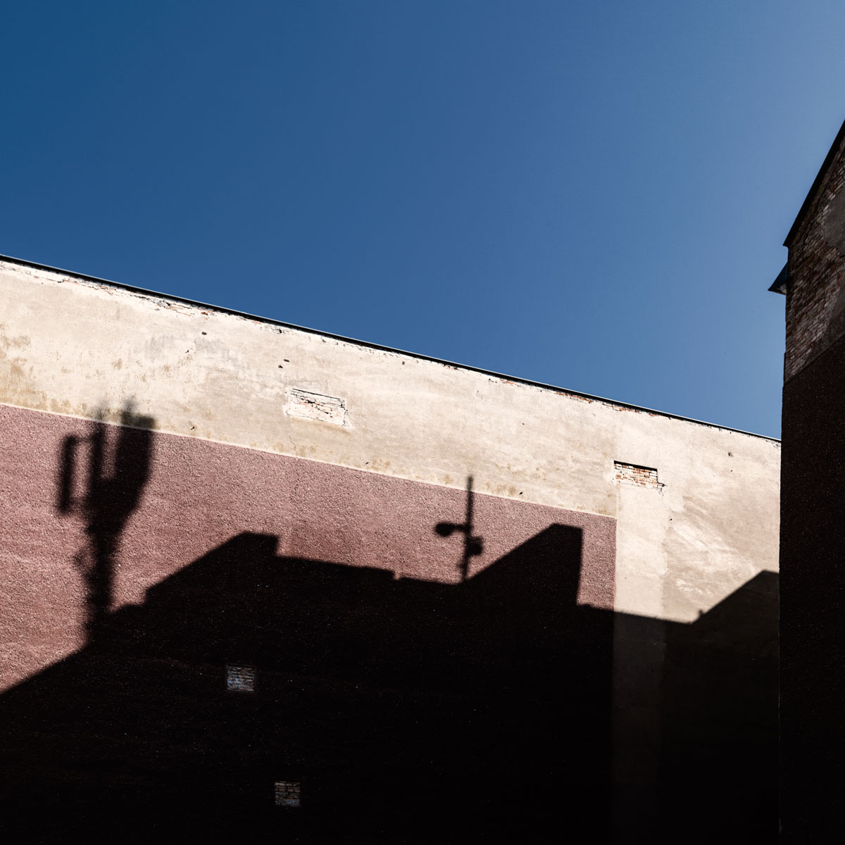 shadows of a building and a blue sky