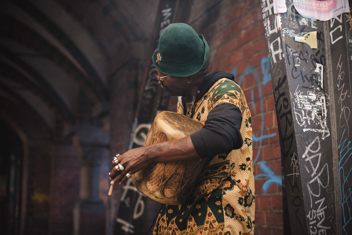 a person in a hat playing a drum