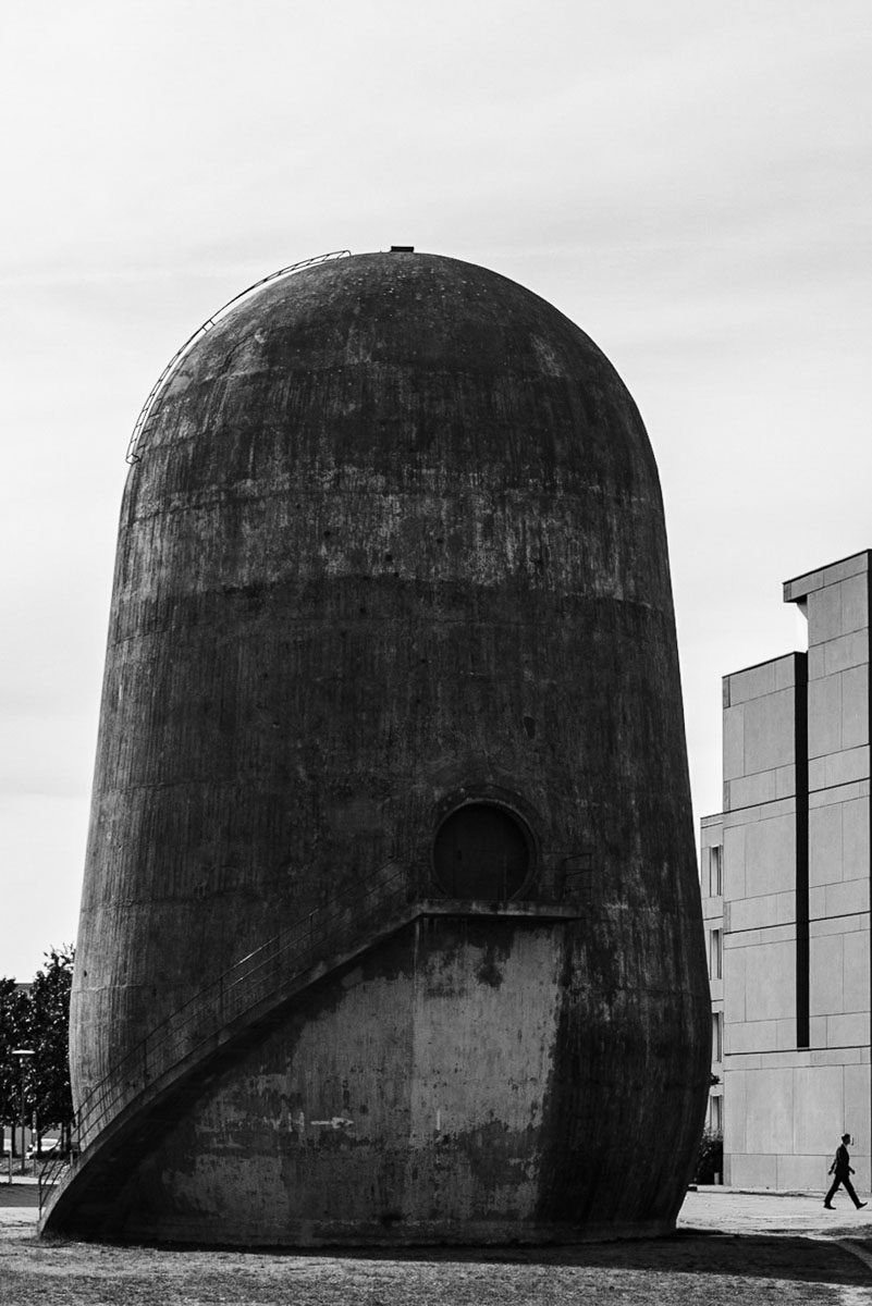 a round concrete structure with a round door