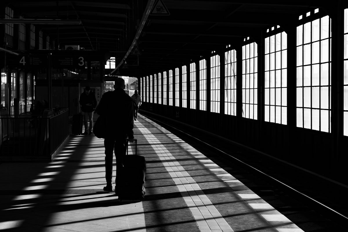 a person walking with luggage in a train station